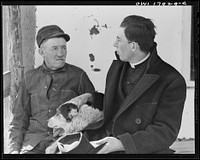 Taos County, New Mexico. Father Cassidy, the Catholic priest of the parish of Penasco with his father who is a rancher in Mora County. Sourced from the Library of Congress.