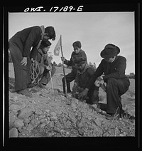 [Untitled photo, possibly related to: Taos County, New Mexico. Father Cassidy, the Catholic priest of the parish of Penasco, telling his troop of Boy Scouts about the science of geology]. Sourced from the Library of Congress.