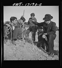 [Untitled photo, possibly related to: Taos County, New Mexico. Father Cassidy, the Catholic priest of the parish of Penasco, telling his troop of Boy Scouts about the science of geology]. Sourced from the Library of Congress.