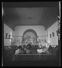 [Untitled photo, possibly related to: Penasco, Taos County, New Mexico. Mass in the village church]. Sourced from the Library of Congress.