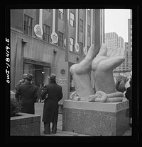 [Untitled photo, possibly related to: New York, New York. "United Nations" exhibition of photographs presented by the United States Office of War Information (OWI) on Rockefeller Plaza. Listening to broadcasts of President Roosevelt, Churchill, Stalin, and Chiang Kai-Chek, heard every half-hour from a loudspeaker at one end of the frame containing the Atlantic charter. This frame is surrounded by four statues of the four freedoms]. Sourced from the Library of Congress.