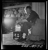 [Untitled photo, possibly related to: Moreno Valley, Colfax County, New Mexico. William Heck, a stockman, churning butter after a hard day in the saddle]. Sourced from the Library of Congress.