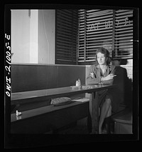 Washington, D.C. Girl sitting alone in the Sea Grill, a bar and restaurant waiting for a pickup. "I come in here pretty often, sometimes alone, mostly with another girl, we drink beer, and talk, and of course we keep our eyes open--you'd be surprised at how often nice, lonesome soldiers ask Sue, the waitress, to introduce them to us". Sourced from the Library of Congress.