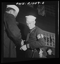 Washington, D.C. Member of the Shore Patrol who helps get servicemen lined up and in order while waiting for special buses to leave the Greyhound bus terminal on Sunday evenings. Sourced from the Library of Congress.