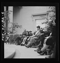 [Untitled photo, possibly related to: Washington, D.C. Listening to a concert at the National Gallery of Art]. Sourced from the Library of Congress.