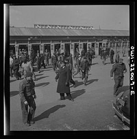 [Untitled photo, possibly related to: Baltimore, Maryland. Workers hurrying to catch a trolley and a trackless trolley at seven a.m.]. Sourced from the Library of Congress.