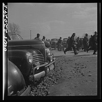 [Untitled photo, possibly related to: Baltimore, Maryland. Workers on the second shift who leave the Bethlehem Fairfield shipyard at three p.m. to get trolleys and automobiles]. Sourced from the Library of Congress.