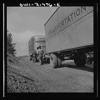 [Untitled photo, possibly related to: Joe Crow along U.S. Highway 29 in Georgia testing a tire by kicking it]. Sourced from the Library of Congress.