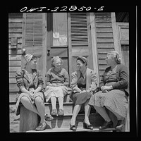 New Orleans, Louisiana. Woman talking in front of a home. Sourced from the Library of Congress.