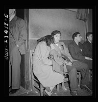 Buffalo, New York. Tired swingshift workers sitting on the sidelines at the swingshift dance held weekly from midnight to 4 a.m. at the Main-Utica ballroom. Sourced from the Library of Congress.