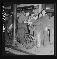 [Untitled photo, possibly related to: Baltimore, Maryland. Third shift workers waiting on a street corner to be picked up by car pools around midnight]. Sourced from the Library of Congress.