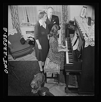 [Untitled photo, possibly related to: Philadelphia, Pennsylvania. Swedish-American executive at the SKF roller bearing factory sings Swedish songs with his wife and daughter]. Sourced from the Library of Congress.