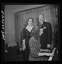 Philadelphia, Pennsylvania. Swedish-American executive at the SKF roller bearing factory sings Swedish songs with his wife and daughter. Sourced from the Library of Congress.
