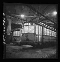 [Untitled photo, possibly related to: Baltimore, Maryland. Trolleys inside the Park terminal at night]. Sourced from the Library of Congress.