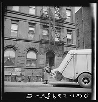 New York, New York. Emptying garbage and trash from Harlem apartment houses. Sourced from the Library of Congress.