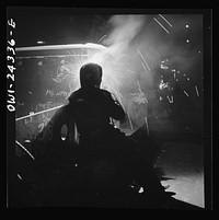 Bethlehem-Fairfield shipyards, Baltimore, Maryland. Welding on a hatch assembly at night. Sourced from the Library of Congress.