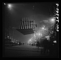 [Untitled photo, possibly related to: Bethlehem-Fairfield shipyards, Baltimore, Maryland. Lifting an after peak section at night]. Sourced from the Library of Congress.