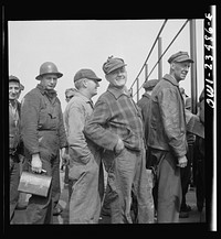 Bethlehem-Fairfield shipyards, Baltimore, Maryland. Lining up before a time clock. Sourced from the Library of Congress.
