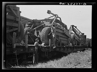 Holabird ordnance depot, Baltimore, Maryland. Careful records of air pressure in a Le-Tourneau roadscraper's giant tires are made before the scrapers are shipped overseas. Ten pounds additional pressure is put in tires before the journey to assure best condition of the tire upon arrival. Sourced from the Library of Congress.