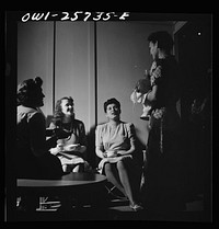 Arlington, Virginia. Girl on her way to the laundry room stops in one of the small alcoves to talk to some of her girlfriends, in a residence for women who work for the government for the duration of the war. Sourced from the Library of Congress.