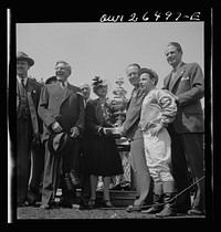Pimlico racetrack, near Baltimore, Maryland. Owner and jockey of Count Fleet receiving Preakness Cup. Sourced from the Library of Congress.