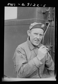 An American soldier trainman has the insignia of the United States Army on the visor of his cap. He is somewhere in Iran. Sourced from the Library of Congress.