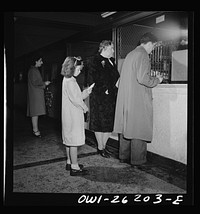 Buffalo, New York. Beverly Ann Grimm, eleven, leaves the two younger girls alone at home while she goes shopping. She is at the bank to cash her mother's check before buying the family food for Sunday. Her mother, a twenty-six year old widow, is a crane operator at Pratt and Letchworth. Sourced from the Library of Congress.