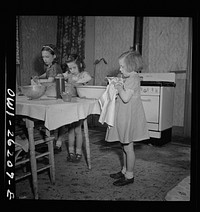 Buffalo, New York. The Grimm children doing the housework. Their mother, a twenty-six year old widow, is a crane operator at Pratt and Letchworth. Sourced from the Library of Congress.