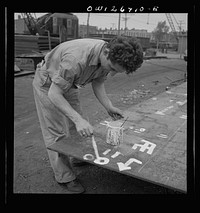 Bethlehem-Fairfield shipyards, Baltimore, Maryland. Painting identification numbers on the steel plates. Sourced from the Library of Congress.
