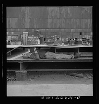 Bethlehem-Fairfield shipyards, Baltimore, Maryland. Worker resting during lunch hour. Sourced from the Library of Congress.