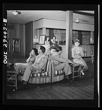 Arlington, Virginia. The main lounge in Idaho Hall, Arlington Farms, a residence for women who work in the United States government for the duration of the war. Sourced from the Library of Congress.