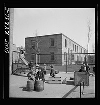 Buffalo, New York. Lakeview nursery school for children of working mothers, operated by the Board of Education at a tuition fee of three dollars weekly. Playing in the well-equipped yard. Sourced from the Library of Congress.
