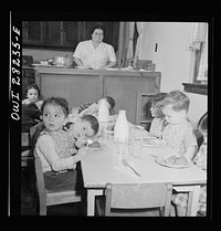 [Untitled photo, possibly related to: Buffalo, New York. Lakeview nursery school for children of working mothers, operated by the Board of Education at a tuition fee of three dollars weekly. Eating lunch consists of meat and vegetables, milk, prune whip]. Sourced from the Library of Congress.