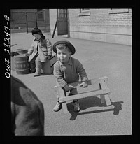 Buffalo, New York. Lakeview nursery school for children of working mothers, operated by the Board of Education at a tuition fee of three dollars weekly. Gary busy building contraptions in the well-equipped yard. Sourced from the Library of Congress.