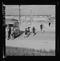 Arlington Farms, war duration residence halls. Crossing road in the front of Arlington Farms. A military police man acts as a traffic officer. Sourced from the Library of Congress.