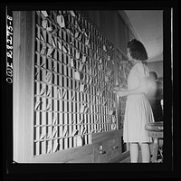 Arlington Farms, war duration residence halls. Desk clerk sorting the mail at Idaho Hall, Arlington Farms. Sourced from the Library of Congress.