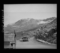 Somewhere in the Persian corridor. A United States Army truck convoy carrying supplies for the aid of Russia. Part of the convoy pulling up a mountain road. The convoy leader in a jeep at the left. Sourced from the Library of Congress.