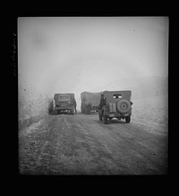 Somewhere in the Persian corridor with a United States convoy carrying supplies for the aid of Russia. Having a bad moment on the snowbound mountain pass as the American trucks ease by a disabled truck. Sourced from the Library of Congress.