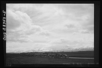 Somewhere in the Persian corridor. A United States Army truck convoy carrying supplies for Russia making a rest stop in a beautiful setting of clouds and snowcapped mountains. Sourced from the Library of Congress.