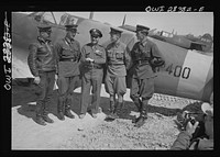 Somewhere in Iran. Major General Lewis Brererton in the center, the Commander of the United States Army force in the Middle East, with a group of Russian officers standing before an American warplane delivered to the Russians. A United States warplane is being tested in the background and bears the red star insignia of Russia, which is made by filling in the white star of the United States with red paint. Sourced from the Library of Congress.