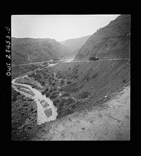 Somewhere in the Persian corridor. A United States Army truck convoy carrying supplies for the aid of Russia winding its way around a gorge over a mountain pass. Sourced from the Library of Congress.