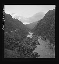 Somewhere in the Persian corridor. A United States Army truck convoy carrying supplies for Russia on a mountain road which winds along the mountainside with a sheer drop into the gorge on one side. Sourced from the Library of Congress.