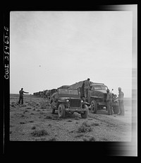Somewhere in the Persian corridor. A United States Army truck convoy carrying supplies for Russia making a rest stop in the desert. Sourced from the Library of Congress.