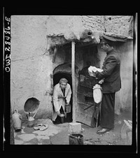 Teheran, Iran. Mrs. Louis Dreyfus, wife of the United States Minister to Iran, distributing food to natives. Sourced from the Library of Congress.