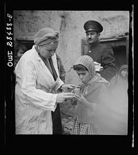 Teheran, Iran. Mrs. Louis Dreyfus, wife of the United States Minister to Iran, giving food to native children. Sourced from the Library of Congress.