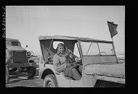OWI (Office of War Information) photographer Nick Parrino somewhere in the Persian corridor in the Jeep in which he rode to make a photographic record of the first run by an all American United States Army convoy carrying supplies for Russia. Sourced from the Library of Congress.