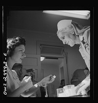 Washington, D.C. American Red Cross volunteer nurse's aide offering refreshments to a blood donor at the center. Sourced from the Library of Congress.