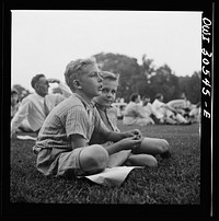 [Untitled photo, possibly related to: Washington, D.C. Listening to the U.S. Army band play at a free concert in front of the Capitol]. Sourced from the Library of Congress.