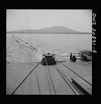 Spring pulpwood drive on the Brown Company timber holdings in Maine. On its return trip up Mooselookmeguntic Lake, the steamer tows an empty boom to be refilled for the next day's load. Sourced from the Library of Congress.