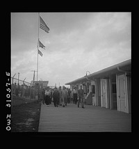 [Untitled photo, possibly related to: Beaumont, Texas. Workers leaving the Pennsylvania shipyards at the change of shift]. Sourced from the Library of Congress.